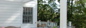 White Pergola Over Patio with Bar in Backyard