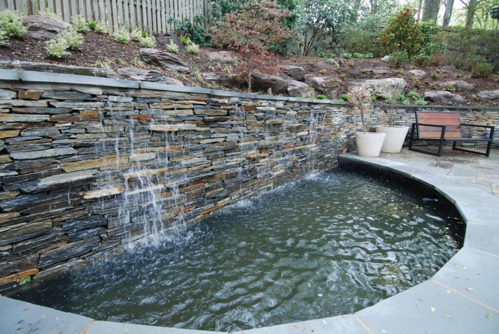 Stone Waterfall Flowing into Pond