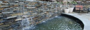 Stone Waterfall Flowing into Pond